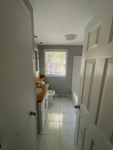 a bathroom with a window and a shower