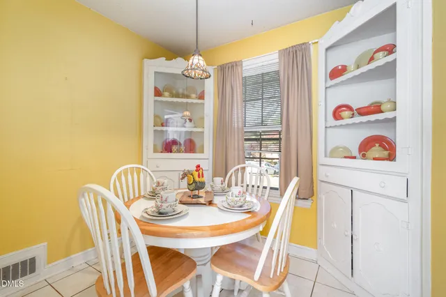 a dining room with furniture and chandelier