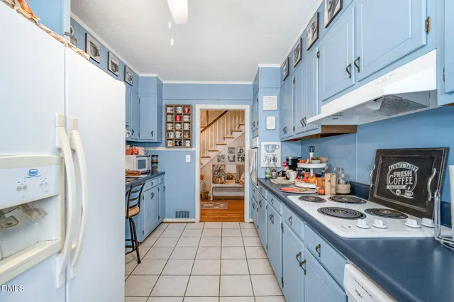 a kitchen with stainless steel appliances granite countertop a refrigerator and a stove