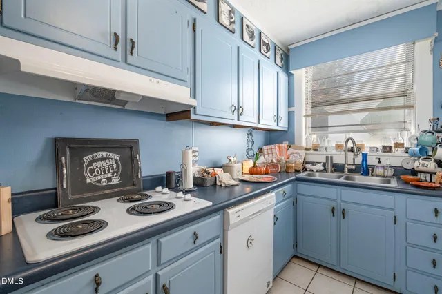 a kitchen with appliances cabinets and a window