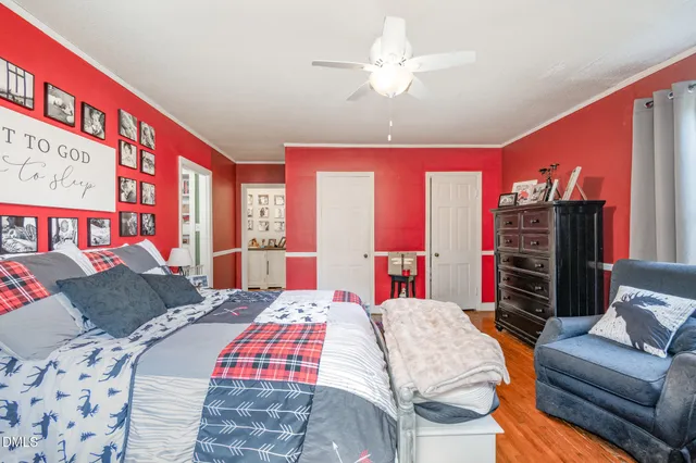 a bedroom with a bed dresser and a flat screen tv