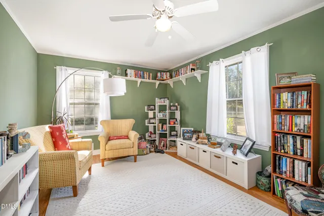 a living room with furniture and a book shelf