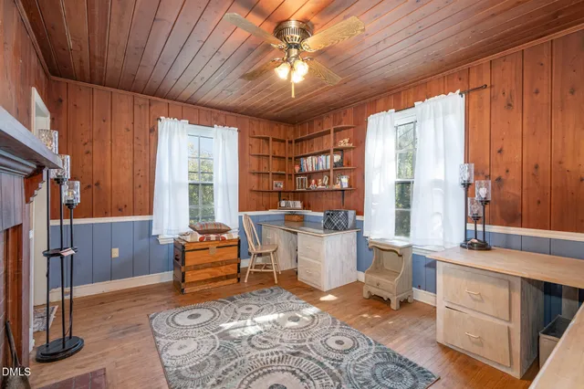 a living room with furniture a large window and a chandelier