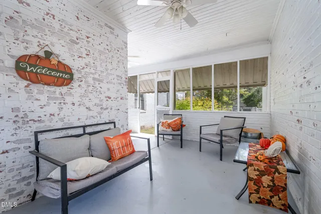 a reading room with furniture and a floor to ceiling window