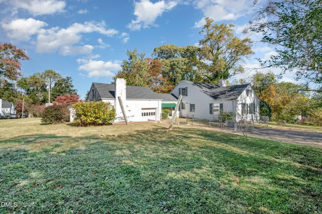 a view of a house with a yard and a garden