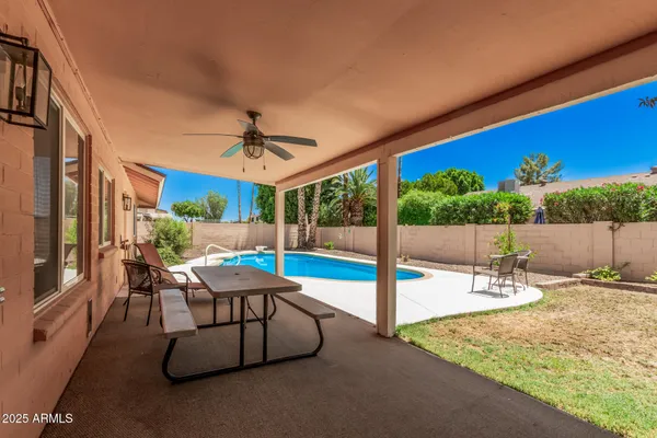 a view of a patio with a table and chairs