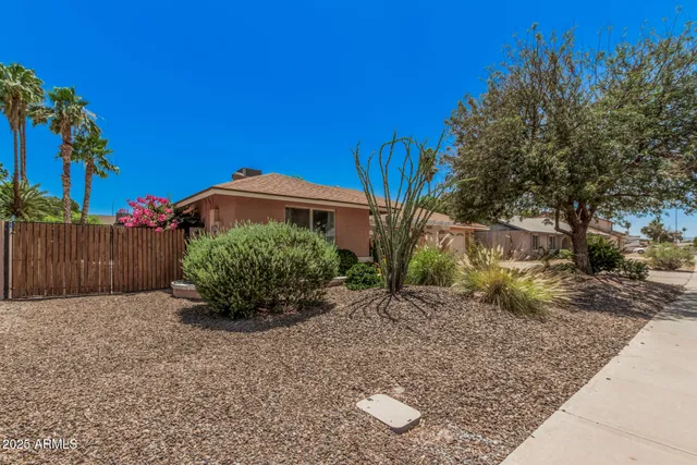 a view of a house with a yard and plants