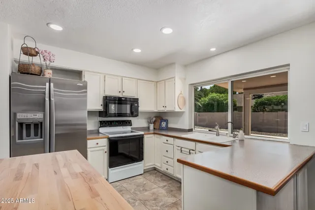 a kitchen with kitchen island a sink stove and refrigerator