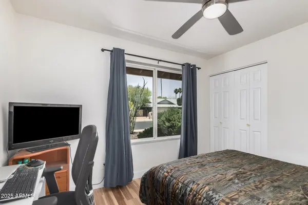 a bedroom with a bed and glass window