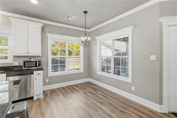 a view of a kitchen with granite countertop a stove and a large window
