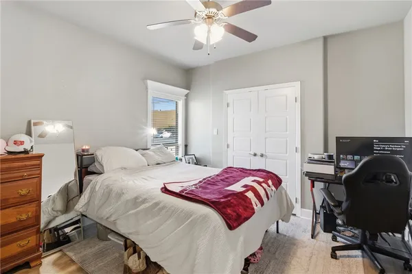a bedroom with a bed and a chandelier