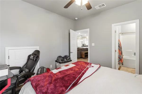 a bedroom with bed and a chandelier