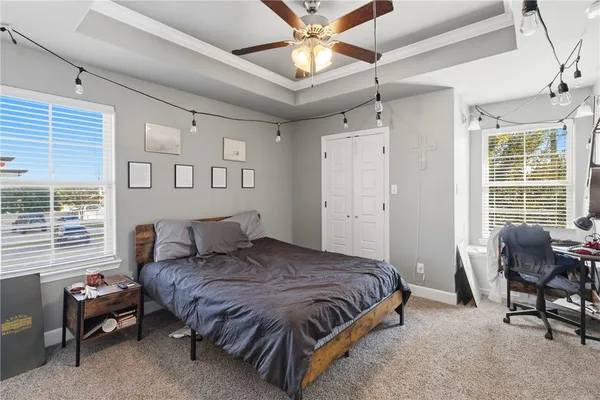 a spacious bedroom with a bed and a chair