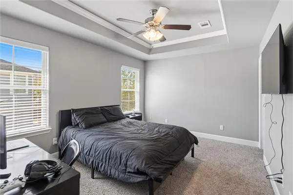 a bedroom with a bed and a tv