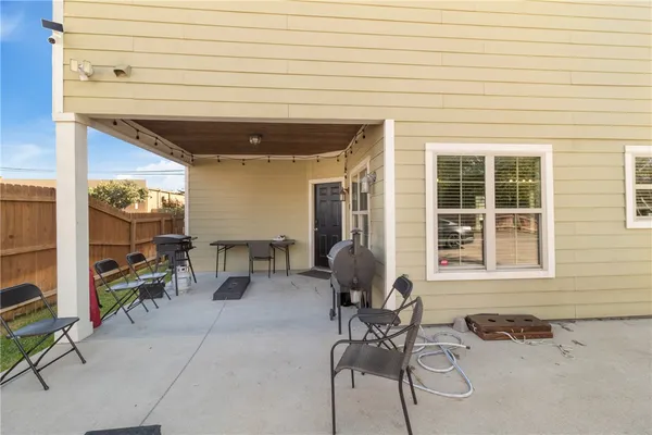 a dining area with furniture and a potted plant