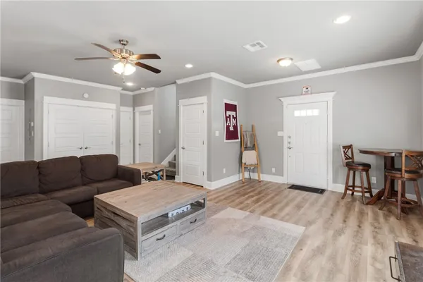 a living room with furniture and a wooden floor