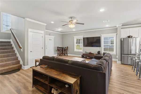 a living room with furniture a flat screen tv and a fireplace
