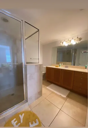 a bathroom with a tub shower and sink