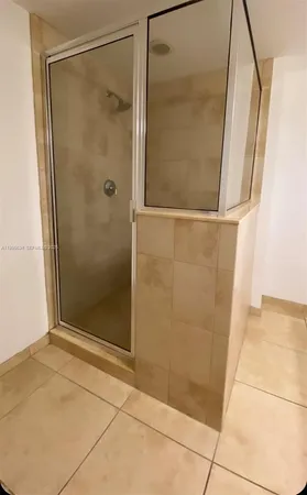 a bathroom with a glass door shower