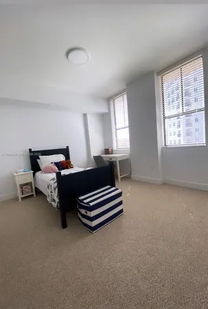 a spacious bedroom with a bed and a window