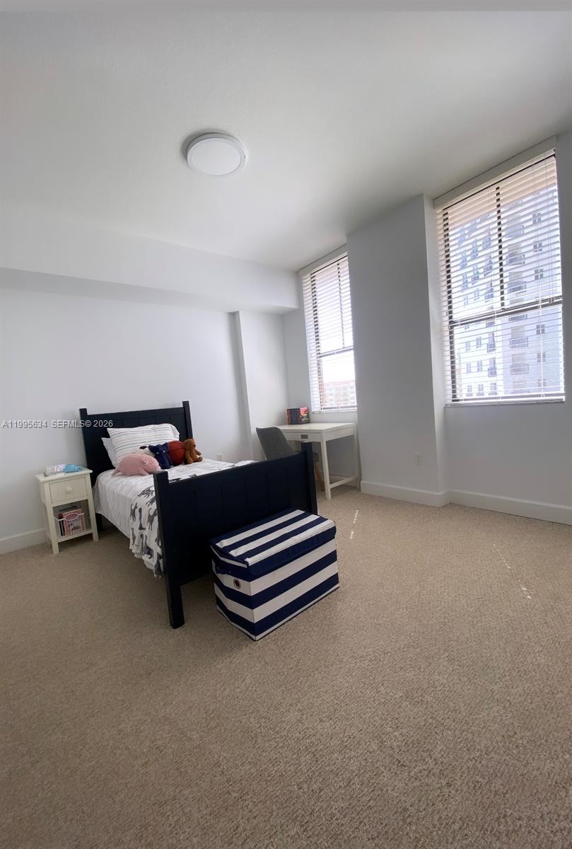 55 Merrick Way, Unit 800 Coral Gables, FL 33134 - Photo 18 of 33 a spacious bedroom with a bed and a window