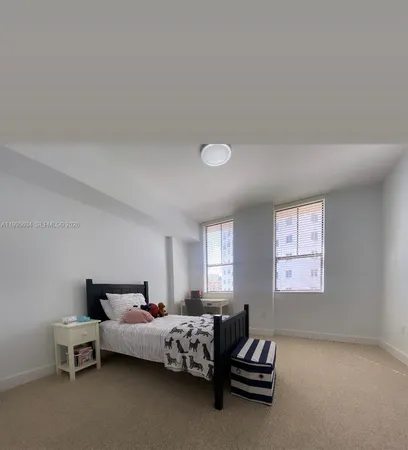a bedroom with bed and window