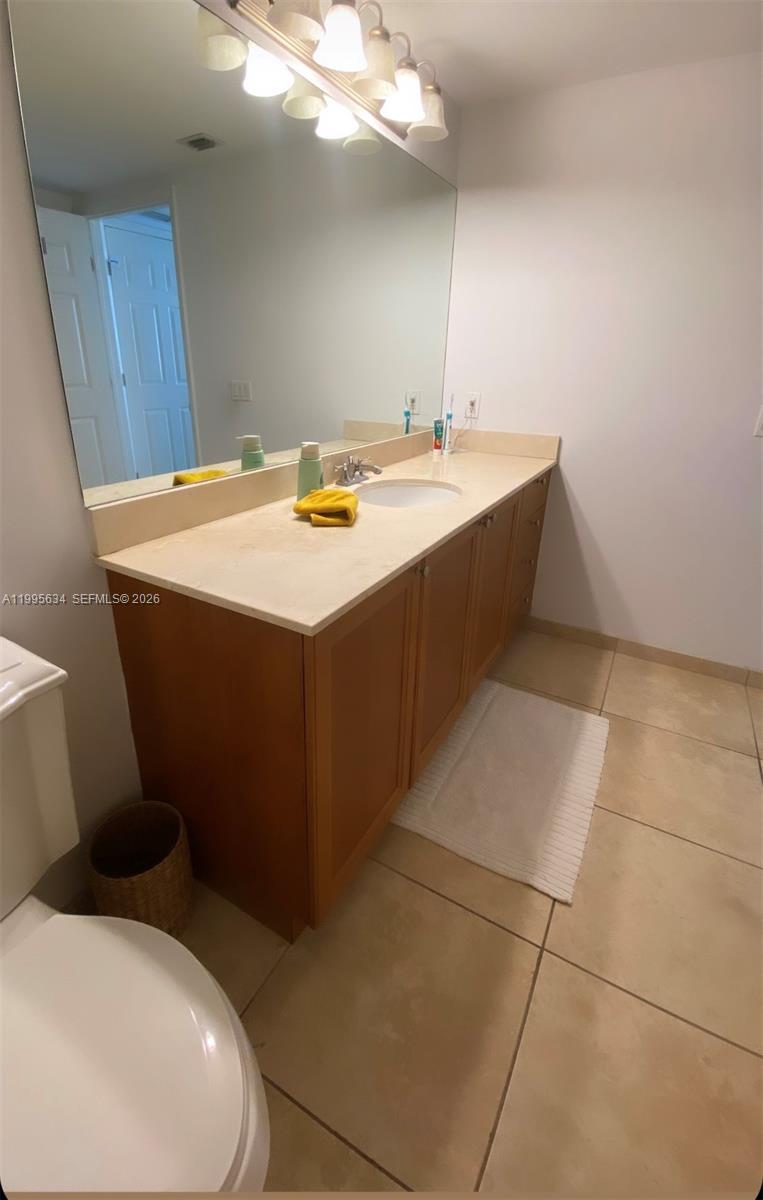55 Merrick Way, Unit 800 Coral Gables, FL 33134 - Photo 21 of 33 a bathroom with a sink a toilet and mirror