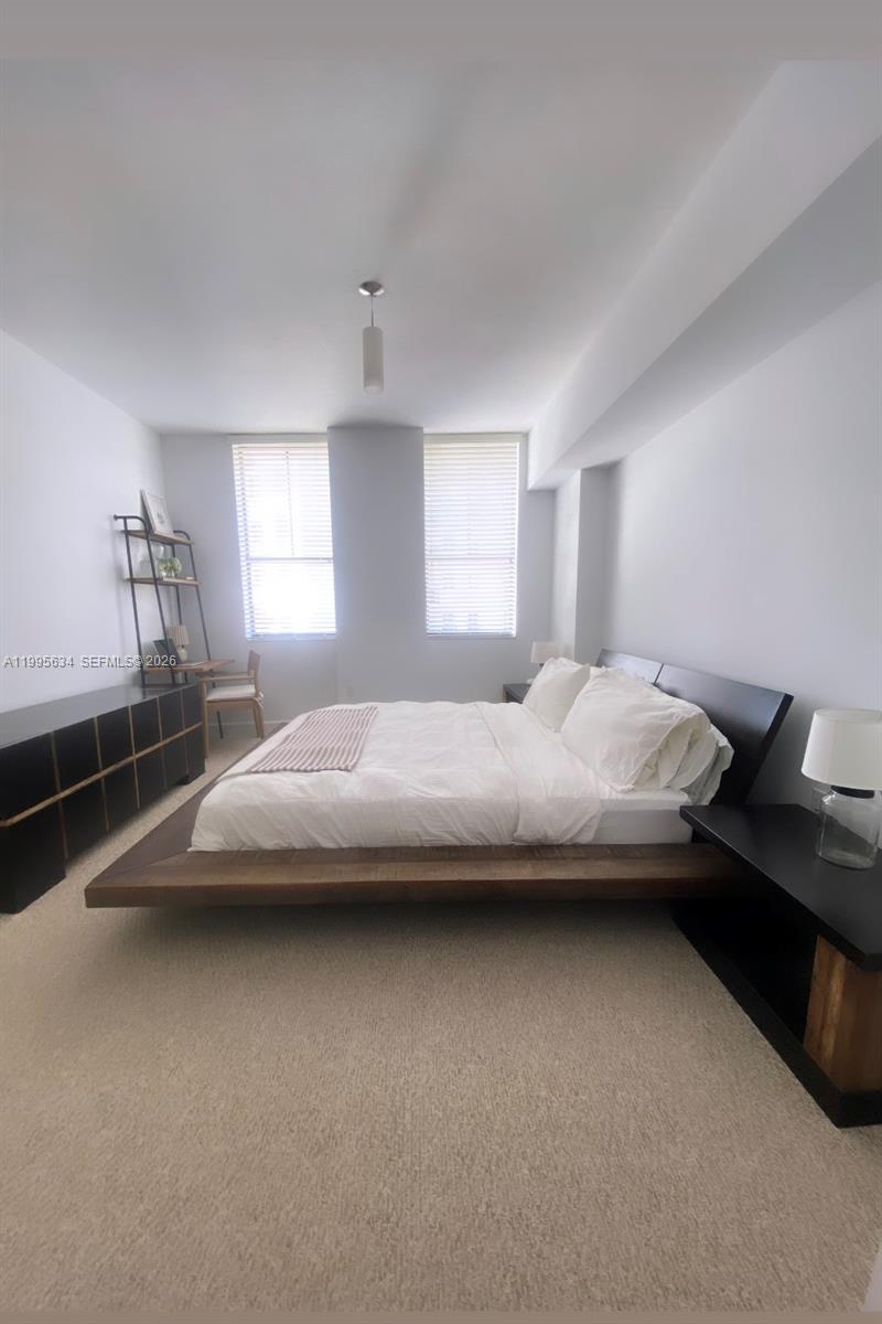 55 Merrick Way, Unit 800 Coral Gables, FL 33134 - Photo 23 of 33 a bedroom with a bed and a window
