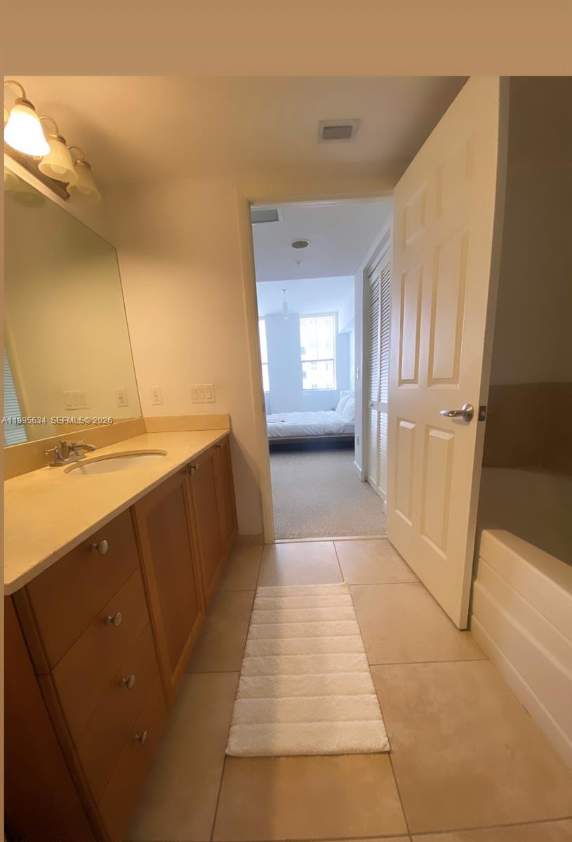 55 Merrick Way, Unit 800 Coral Gables, FL 33134 - Photo 24 of 33 a view of a bathroom with a sink and a tub