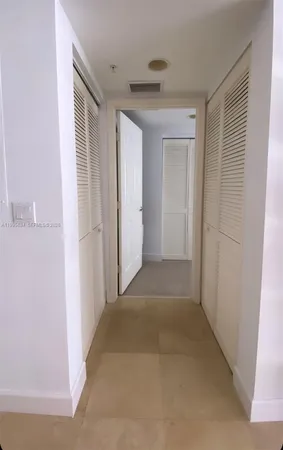 a view of a hallway to a bedroom