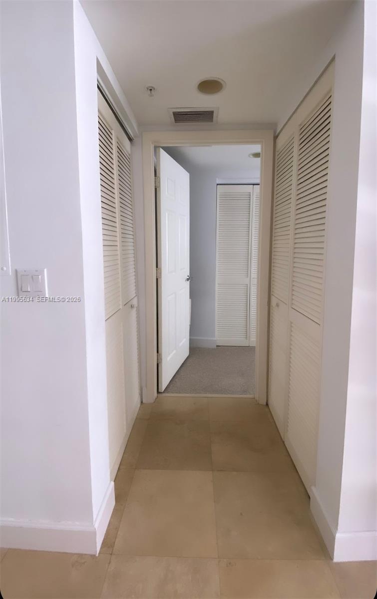 55 Merrick Way, Unit 800 Coral Gables, FL 33134 - Photo 6 of 33 a view of a hallway to a bedroom