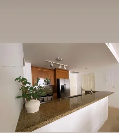 a view of a living room and kitchen