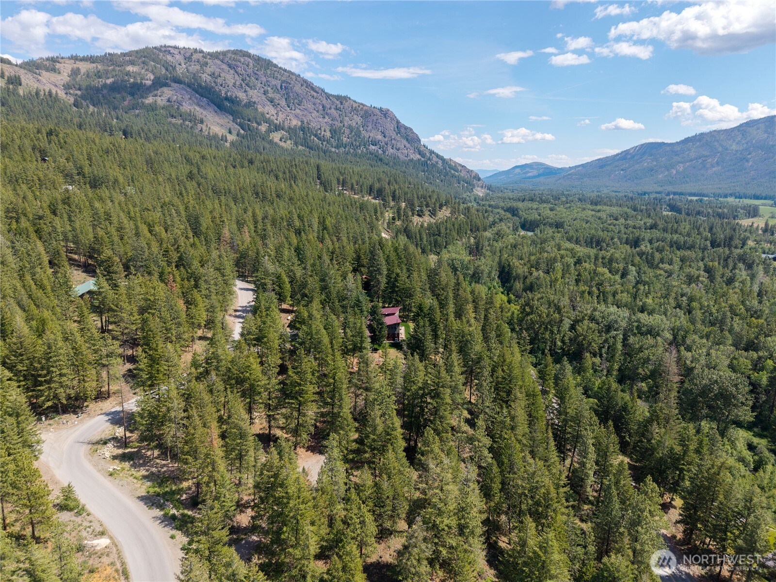 6 Homestead Road Winthrop, WA 98862 - Photo 32 of 40 a view of a lush green hillside and a mountain
