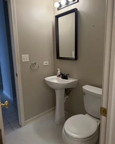 a white toilet sitting next to a bathroom sink