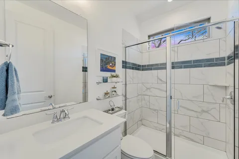 a bathroom with a sink toilet and shower