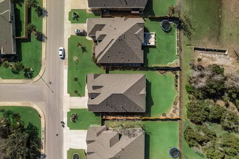 an aerial view of a house with a swimming pool