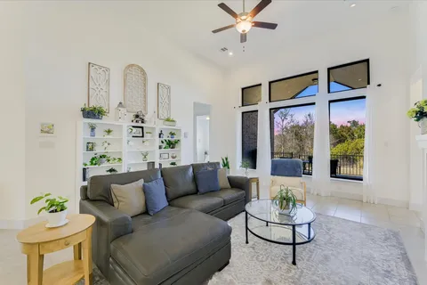 a living room with furniture and a large window