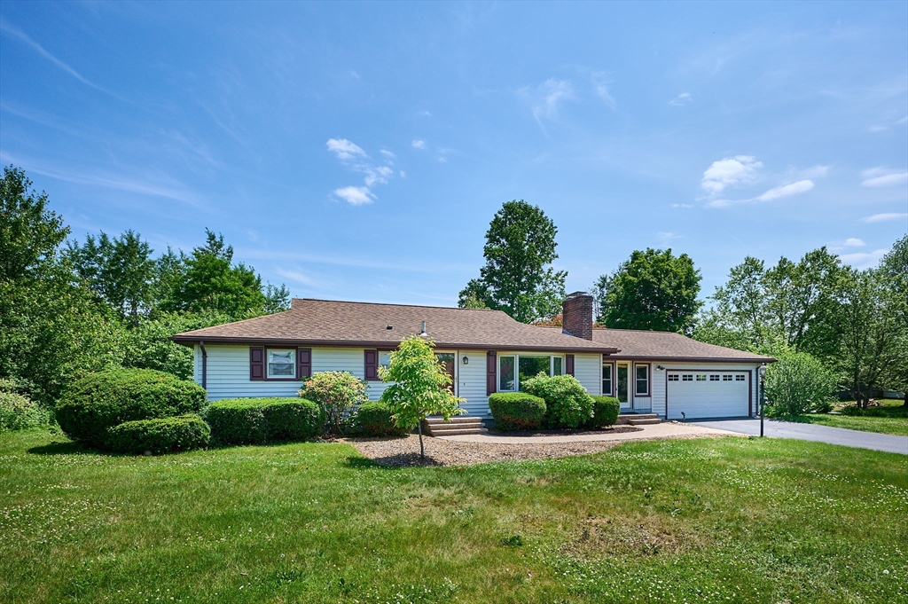 985 Tinkham Road Wilbraham, MA 01095 - Photo 1 of 27 a front view of a house with a yard and garage