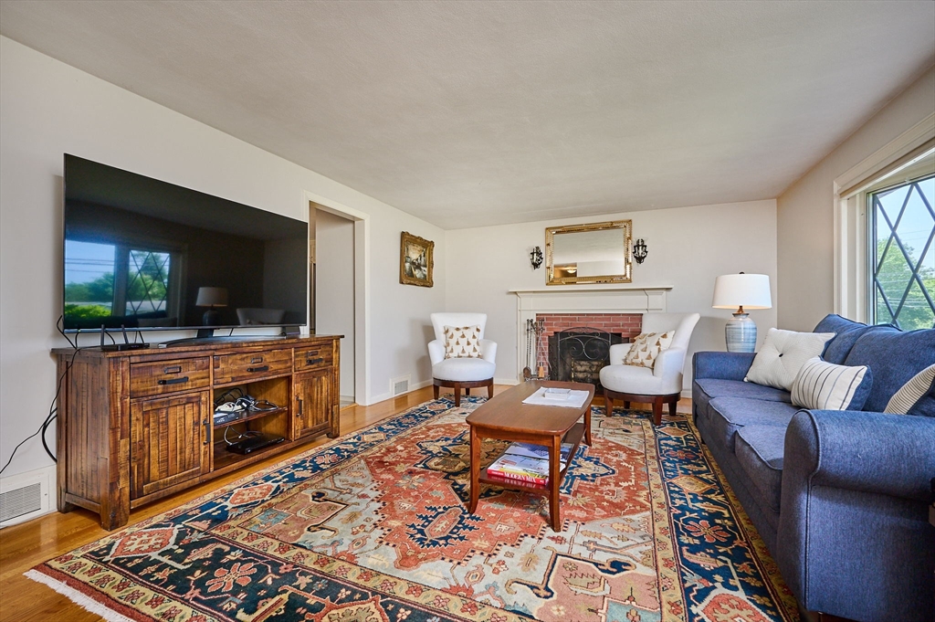985 Tinkham Road Wilbraham, MA 01095 - Photo 11 of 27 a living room with furniture and a flat screen tv