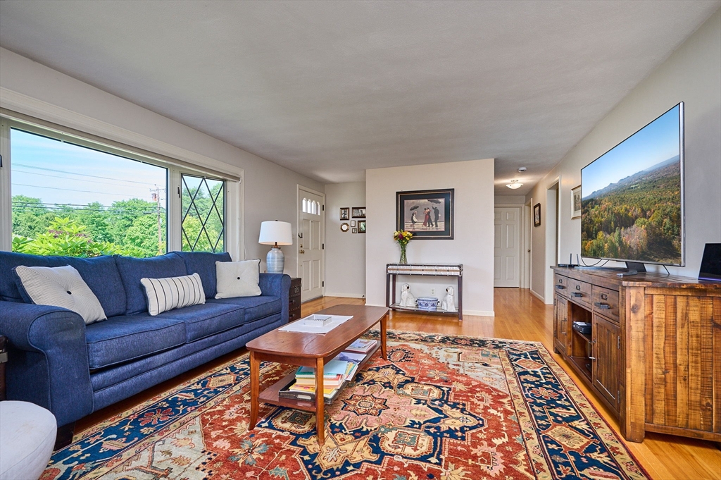 985 Tinkham Road Wilbraham, MA 01095 - Photo 12 of 27 a living room with furniture and a flat screen tv