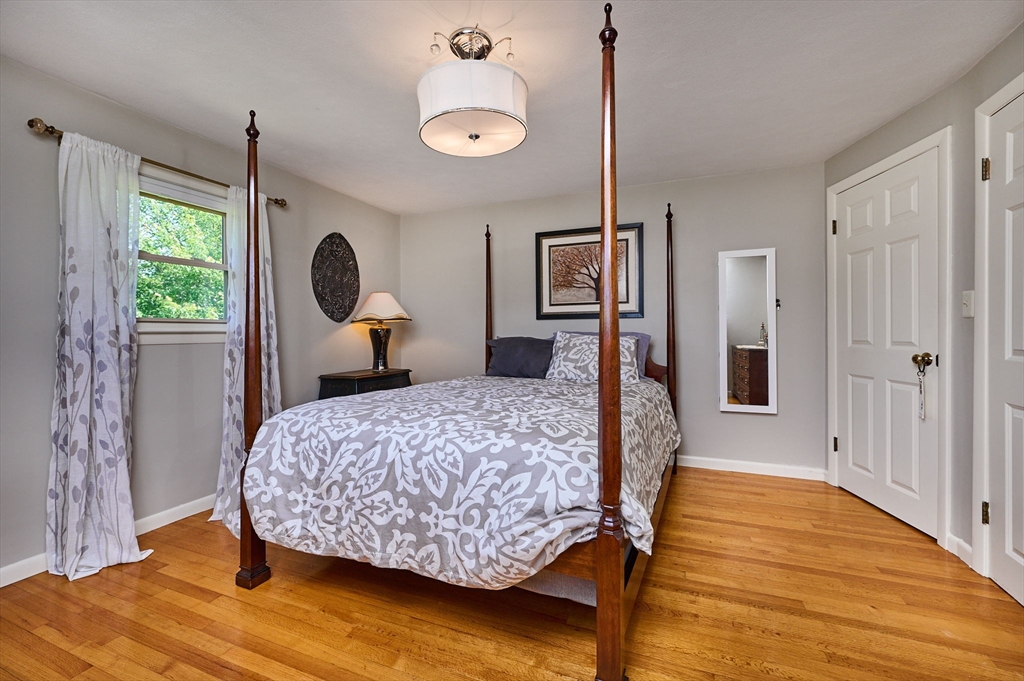 985 Tinkham Road Wilbraham, MA 01095 - Photo 16 of 27 a bedroom with a bed window and a wooden floor