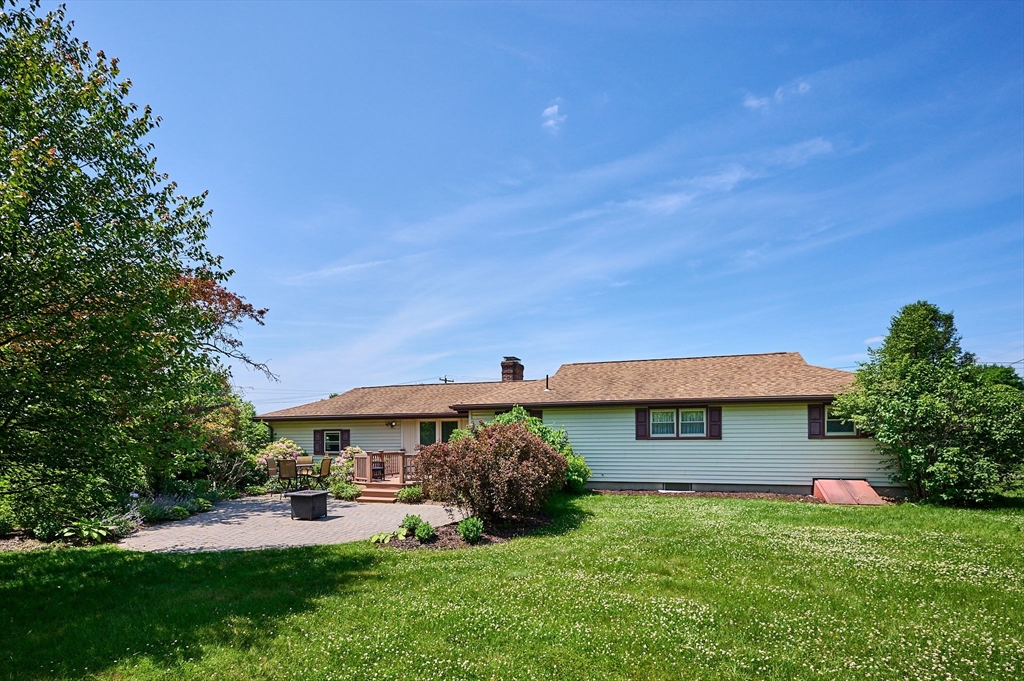 985 Tinkham Road Wilbraham, MA 01095 - Photo 20 of 27 a front view of a house with a garden and deck