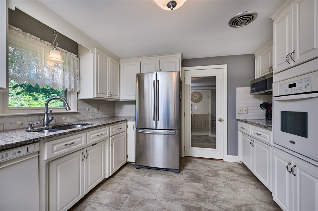 985 Tinkham Road Wilbraham, MA 01095 - Photo 5 of 27 a kitchen with stainless steel appliances granite countertop a refrigerator sink and stove