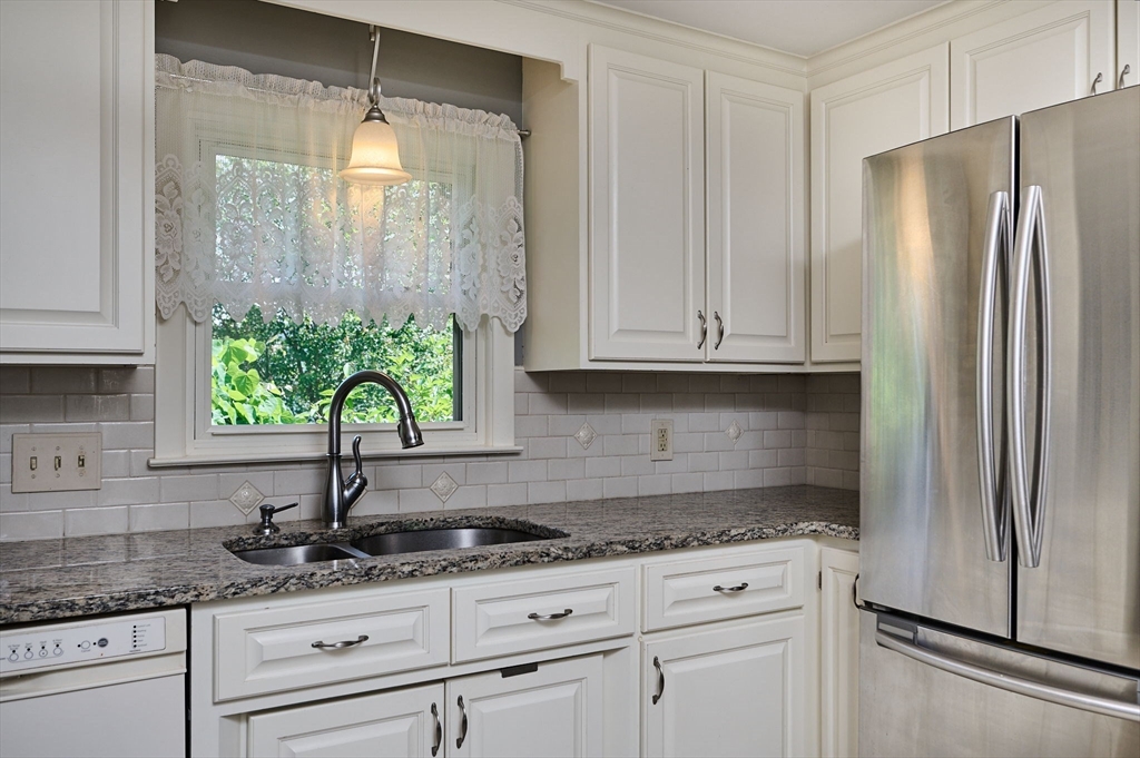 985 Tinkham Road Wilbraham, MA 01095 - Photo 6 of 27 a kitchen with granite countertop white cabinets white appliances and a sink