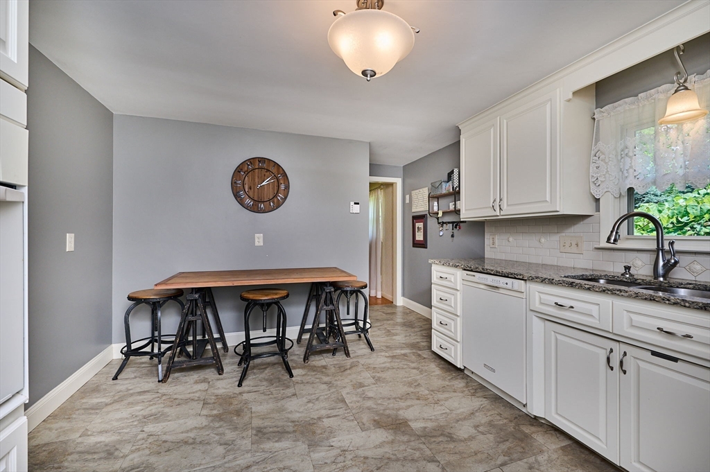 985 Tinkham Road Wilbraham, MA 01095 - Photo 7 of 27 a kitchen with a table chairs and a stove