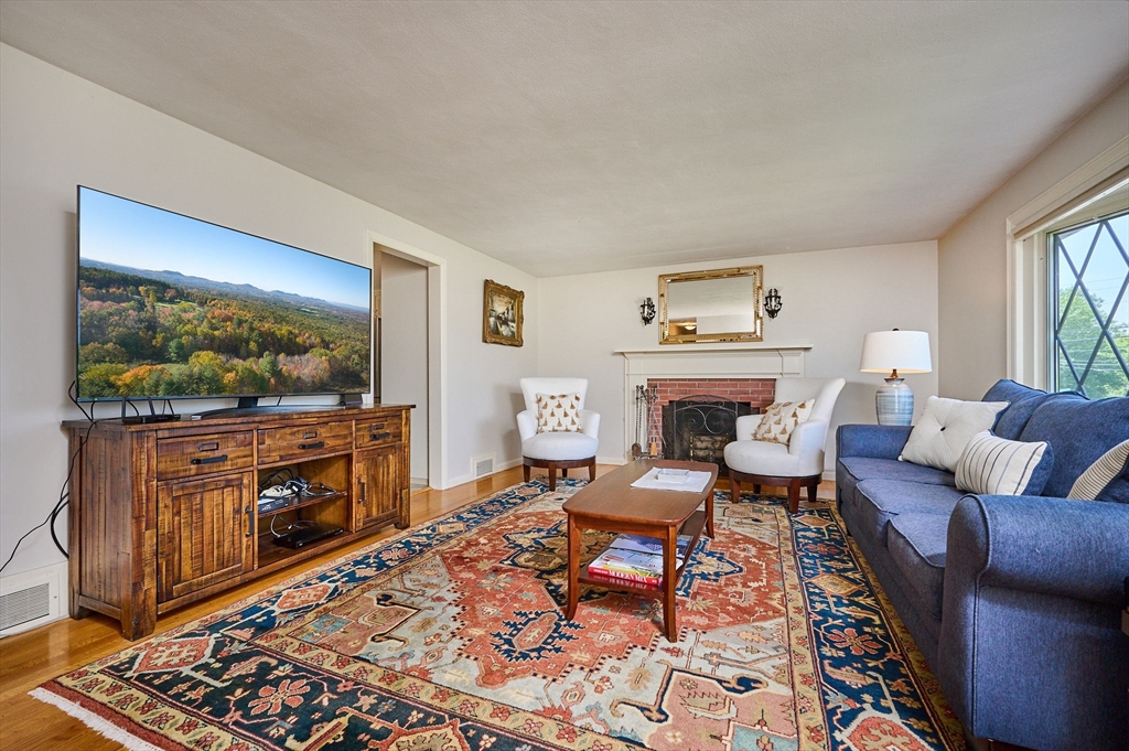 985 Tinkham Road Wilbraham, MA 01095 - Photo 10 of 27 a living room with furniture and a flat screen tv