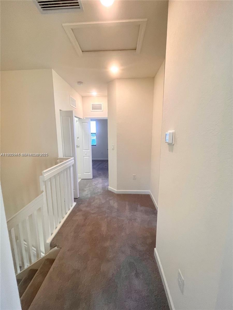 3338 West 112th Street Hialeah, FL 33018 - Photo 16 of 40 a view of hallway with stairs