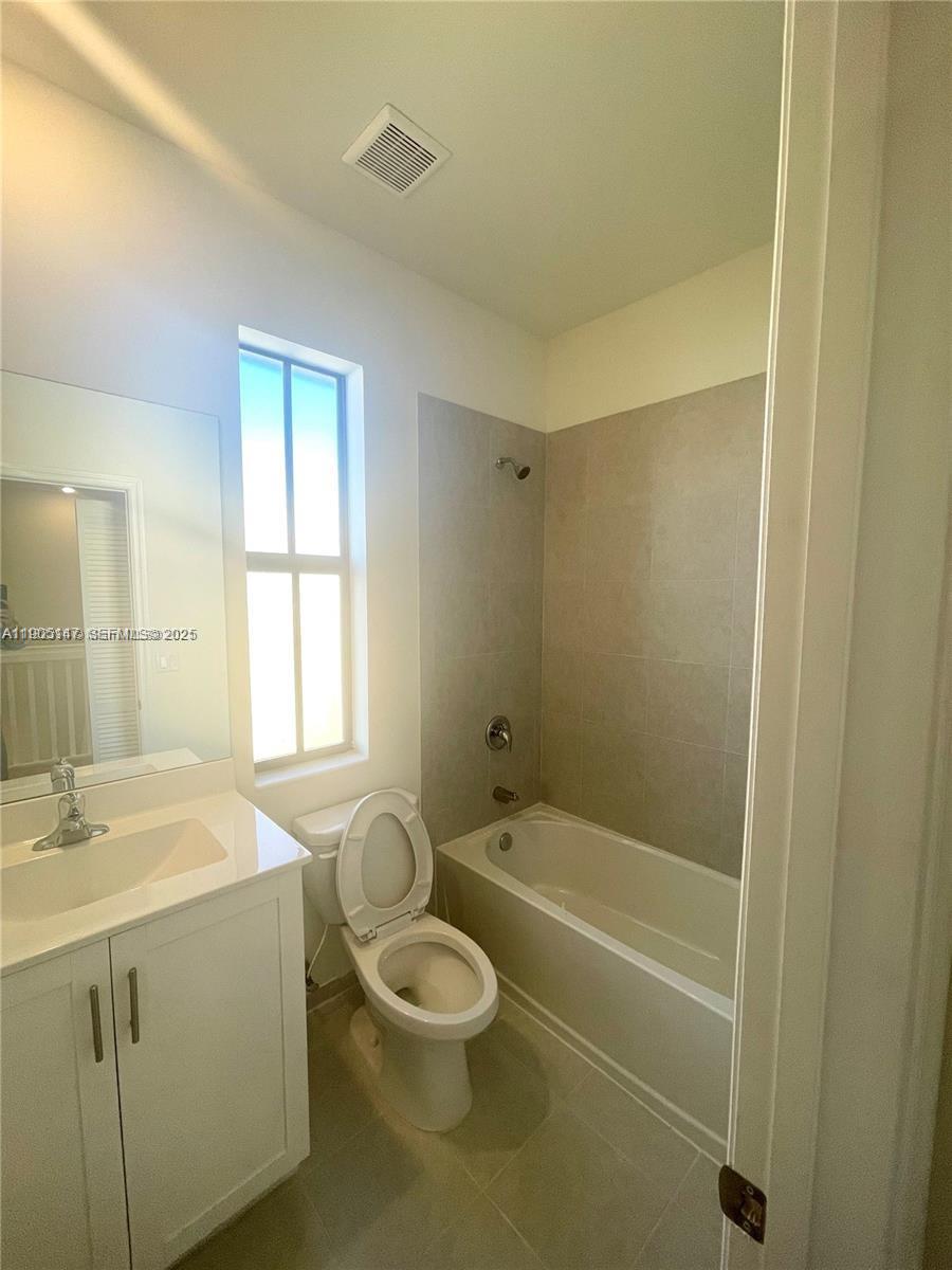 3338 West 112th Street Hialeah, FL 33018 - Photo 24 of 40 a bathroom with a sink a toilet and shower