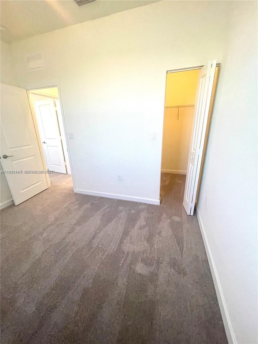 3338 West 112th Street Hialeah, FL 33018 - Photo 32 of 40 an empty room with windows