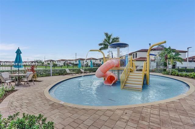 3338 West 112th Street Hialeah, FL 33018 - Photo 39 of 40 a view of a swimming pool with a patio